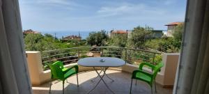 a balcony with a table and chairs and a view at Anna House Dhermi in Dhërmi
