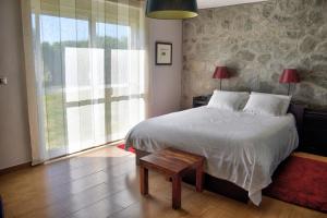 a bedroom with a large bed and a window at Los Olivos Villa in Sanlúcar de Barrameda +24 photos
