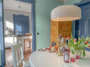 a dining room with a white table with a lamp at traumHaff denkmalgeschützter Amalienhof Sauna, offener Kamin, Hund in Gegensee