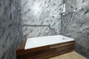 a bathroom with a shower with a white bath tub at ชิดธาร รีสอร์ท in Ban Nong Hoi +48 photos