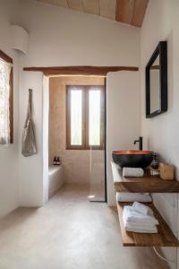 
a bathroom with a sink, toilet and a window at Agroturismo Son Fogueró - Adults Only in Maria de la Salut

