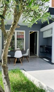 un patio con una sedia bianca e un albero di Garden Rooms a Golem