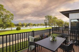 a table on a deck with a view of a river at Berri Hotel in Berri