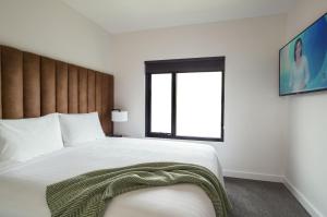 a bedroom with a large white bed with a window at Berri Hotel in Berri
