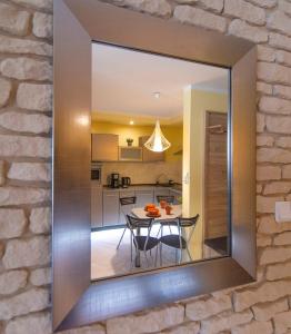 a mirror on the wall of a kitchen with a table at Trevilles Ap.- Martynówka in Szklarska Poręba