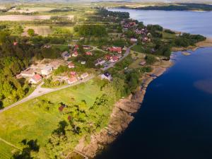 an aerial view of a village on the shore of a lake at Przystań Piława in Borne Sulinowo