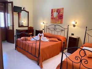 サン・ヴィート・ロ・カーポにあるBaglio Cusenza Roomsのベッドルーム1室(ベッド2台、タオル付)