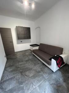 a living room with a couch and a flat screen tv at Grey house in Genoa