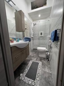 a bathroom with a sink and a toilet at Grey house in Genoa