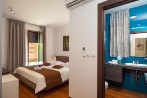 a hotel room with a bed and a bathroom at Alba Residence in Split