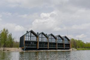 a building in the middle of a body of water at Shepilska Relax Complex in Dovholuka