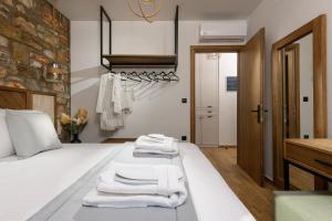a bedroom with a bed with towels on it at La Terra Petra in Skala Rachoniou