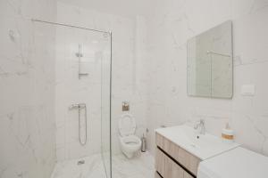 a bathroom with a shower and a toilet and a sink at Trsteno Beach Apartments in Budva