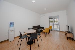 a living room with a table and chairs at Trsteno Beach Apartments in Budva
