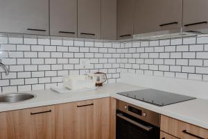 a kitchen with a sink and a counter top at Trsteno Beach Apartments in Budva