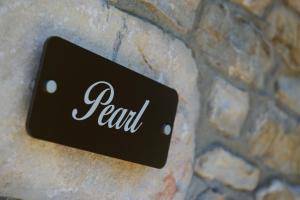 a sign that reads real on a stone wall at La Terra Petra in Skala Rachoniou
