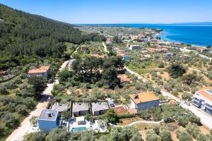 an aerial view of a house and the ocean at La Terra Petra in Skala Rachoniou