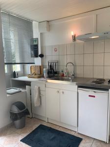 a kitchen with a sink and a counter top at Charmant Studio meublé in Montignac-Charente