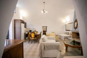 a living room with a couch and a dining room at Mylos villa Mani in Pírgos