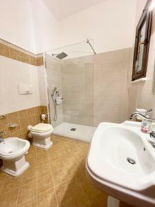 a bathroom with a toilet and a sink and a shower at Civico 22 in Trapani