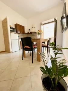 a kitchen with a table and chairs and a dining room at Civico 22 in Trapani