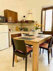 a kitchen with a wooden table and two chairs at Civico 22 in Trapani