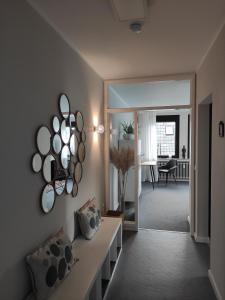 a living room with a couch and mirrors on the wall at Kissinger38 in Detmold
