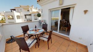 a patio with a table and chairs on a balcony at Casa Pez Espada-A Murcia Holiday Rentals Property in Roldán