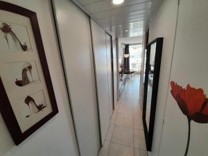 a hallway of a house with a mirror and a floor at Village Naturiste - Port Ambonne in Cap d'Agde
