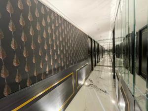 um corredor de um edifício com uma parede com papel de parede de ananás em Gulf Hotel Mumbai- The Boutique Hotel Colaba Mumbai em Mumbai mais 200 fotografias