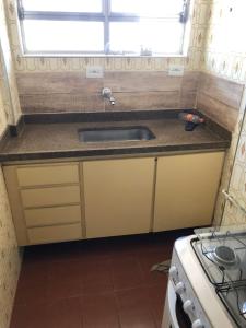 a kitchen with a sink and a stove at Rub-a-Dub in Santos