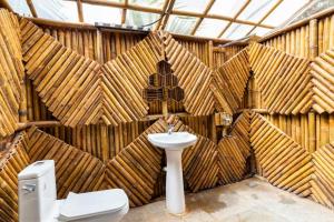 a bathroom with a sink and a toilet at Vagatorian - Stylish Luxury Designer Cottages in Vagator