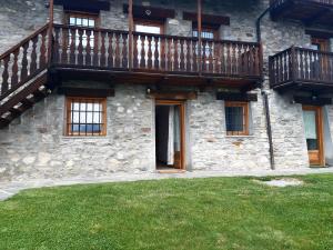 a stone building with a balcony and a yard at STOP & STARE STARS in Lignan