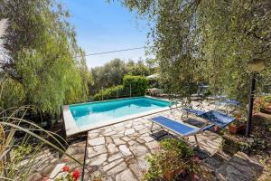 uma piscina num quintal com duas cadeiras em Casa Paola em Costa Carnara