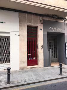 a red door on the side of a building at KALIFORNIA CENTRAL in Alicante