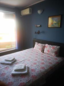 a bedroom with a bed with towels on it at Complex Karia II in Kavarna +62 photos