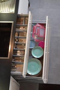 an open drawer with plates and utensils in it at Blockhaus Waldsee 8 in Rieden