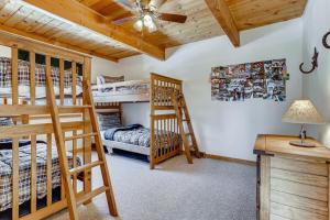 a bedroom with two bunk beds and a desk at Lovely House Tucked in the Pines with Private Hot Tub - Pura Vida in Alma