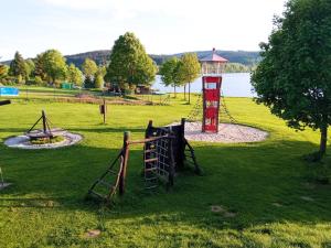 a park with a playground and a play structure at Apartmán C311 in Frymburk