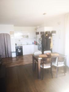 a kitchen and dining room with a table and chairs at Complex Karia II in Kavarna