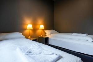 two beds sitting next to each other in a room at The New Post Office in Vestmannaeyjar