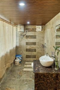 a bathroom with a sink and a toilet at Royal Cliff Resorts in Nainital