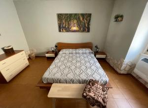 a bedroom with a bed and a table in it at Ninna House in Villa San Sebastiano