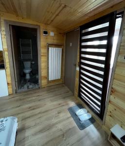 a bathroom with a toilet in a wooden room at Magic Box in Constanţa