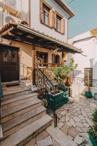 a house with wooden stairs in front of it at Varousi.Traditional house in old town of Trikala 1 in Tríkala