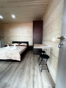 a bedroom with a bed and a table and chairs at Magic Box in Constanţa