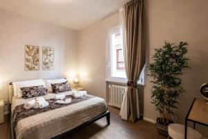 a bedroom with a bed with two stuffed animals on it at Verona Romana Apartments in Verona