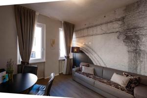 uma sala de estar com um sofá e uma parede de tijolos em Verona Romana Apartments em Verona