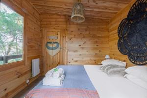 a bedroom with a bed in a wooden cabin at Les Cabanons de l'Ouille in Collioure