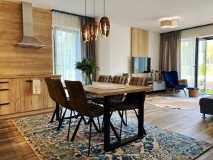 a dining room with a table and chairs at Chata3brezy Vysoké Tatry in Stará Lesná